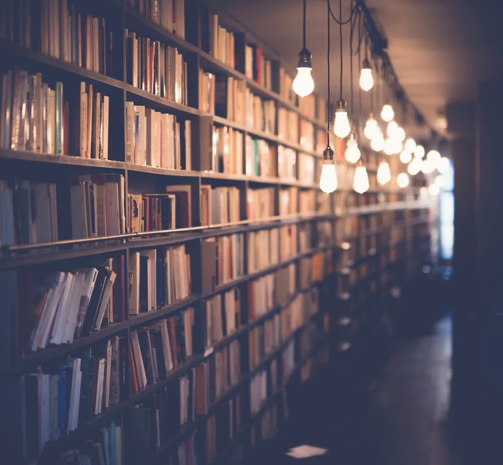 Warmly lit shelves of books in a library